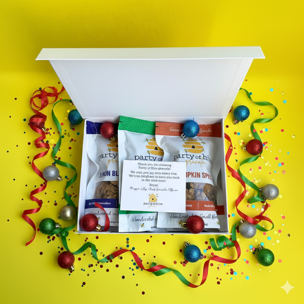 Gift box with Party of Two branded snacks on a yellow background with festive ribbons and ornaments.